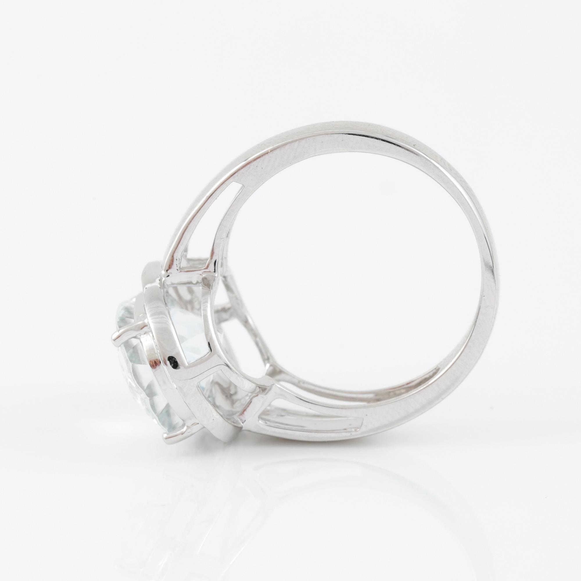 RING, 14k guld med ovalslipad akvamarin tot ca 4,30 ct omgivs av små åttkantslipade diamanter. Vikt 5,55 g.