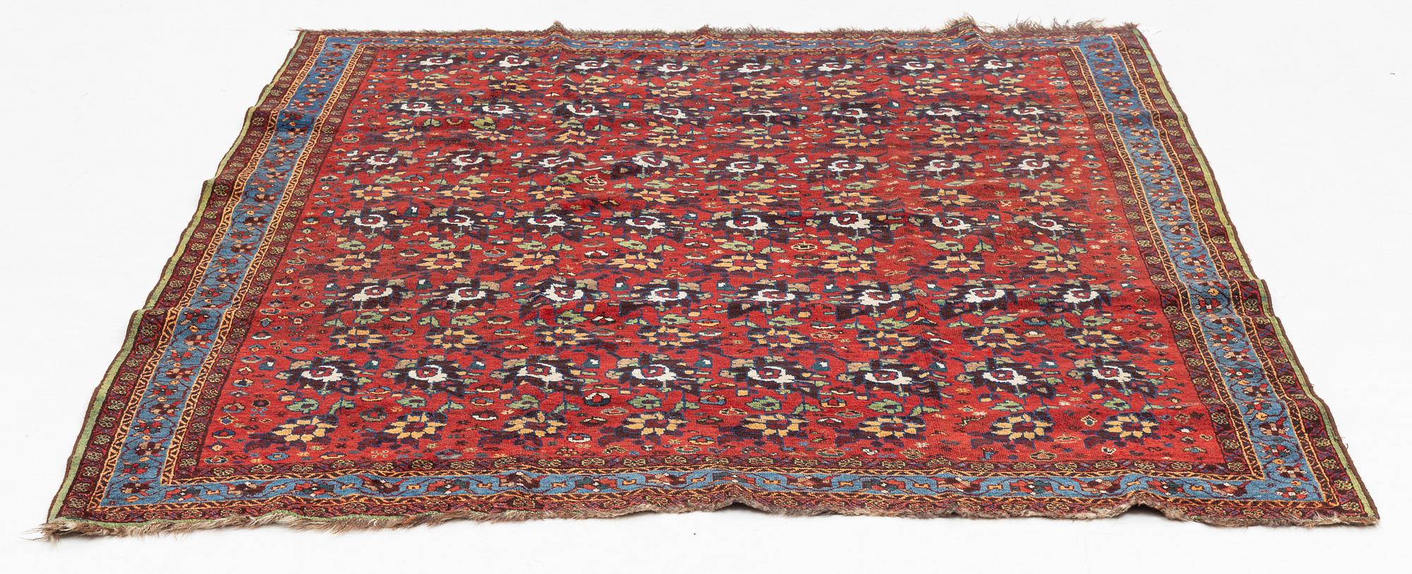 An oriental rug, semi antique, probably Baluch, c. 210 x 170 cm.