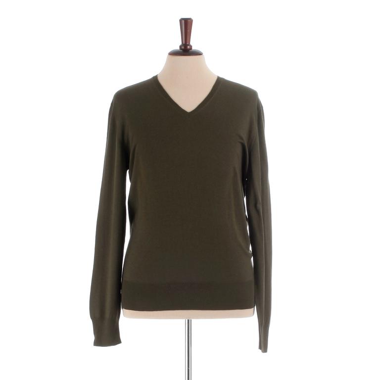 YVES SAINT LAURENT, a men's green wool sweater, size M.