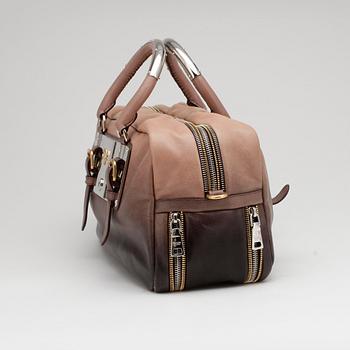 PRADA, a brown leather top handle bag.