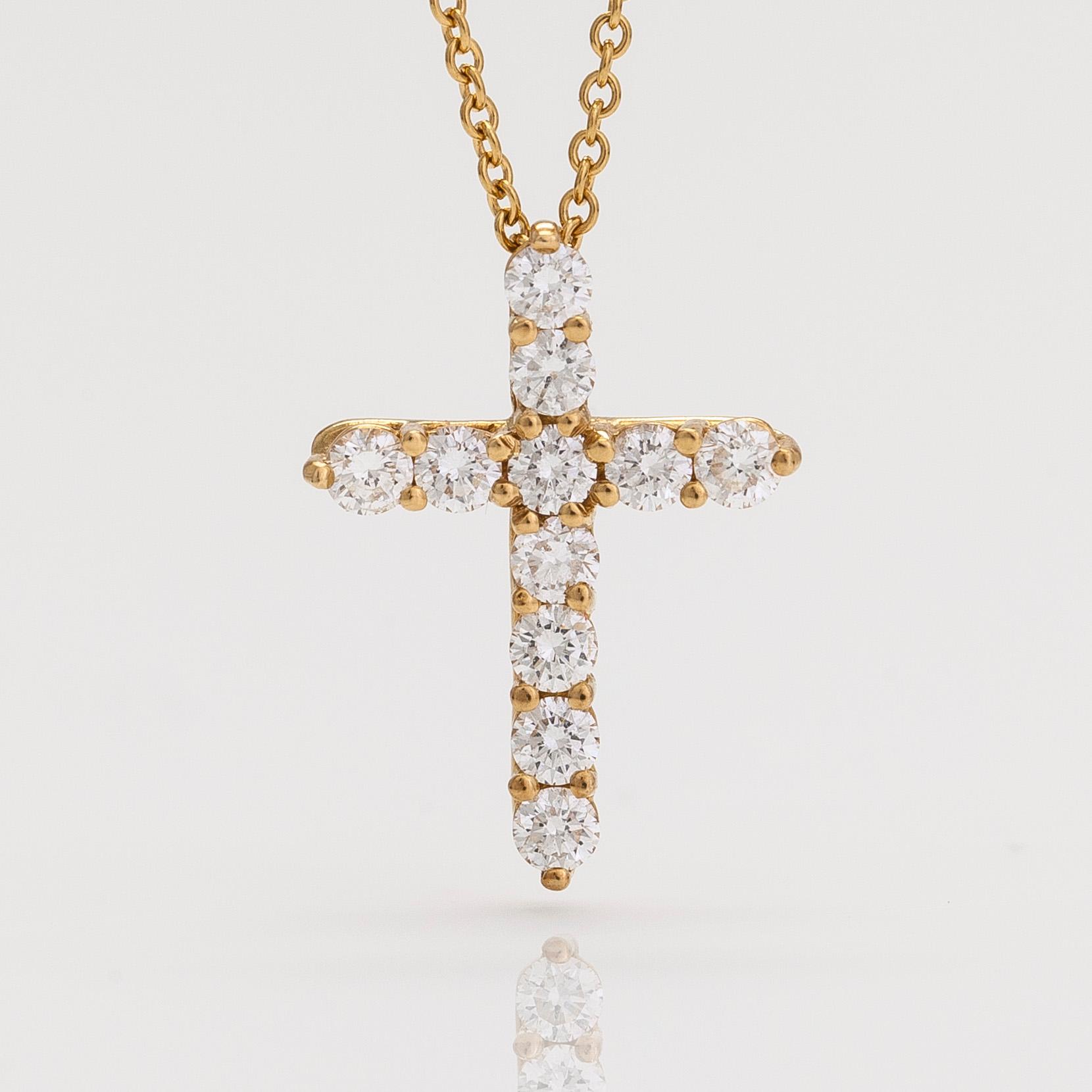 Tiffany & Co, an 18K gold cross pendant necklace with diamonds, ca. 0.42 ct in total.
