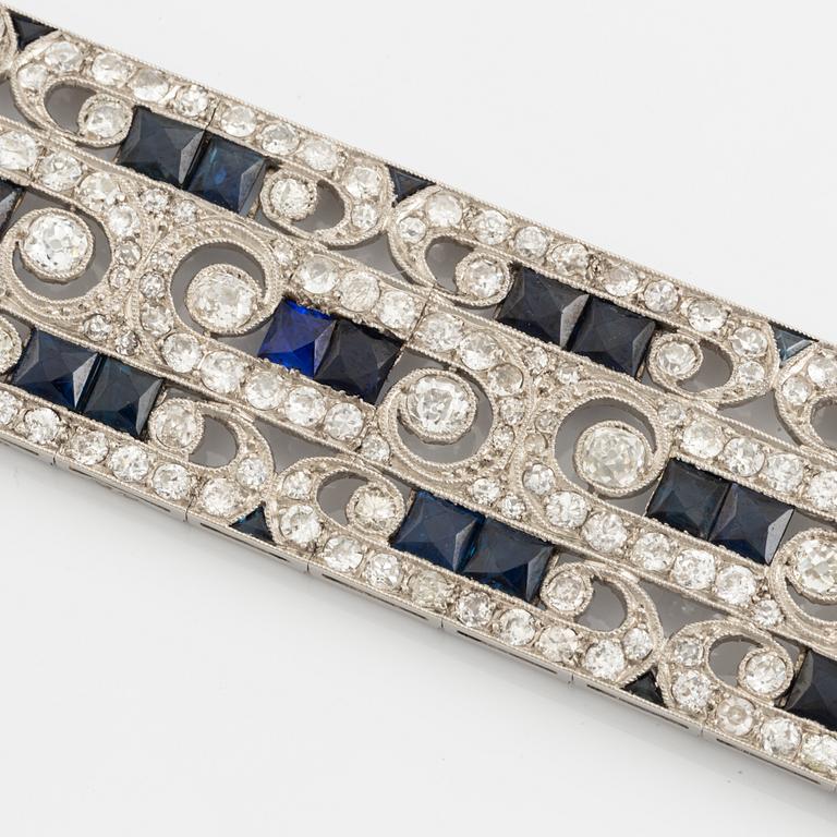 A platinum bracelet set with old-cut diamonds and step-cut sapphires.