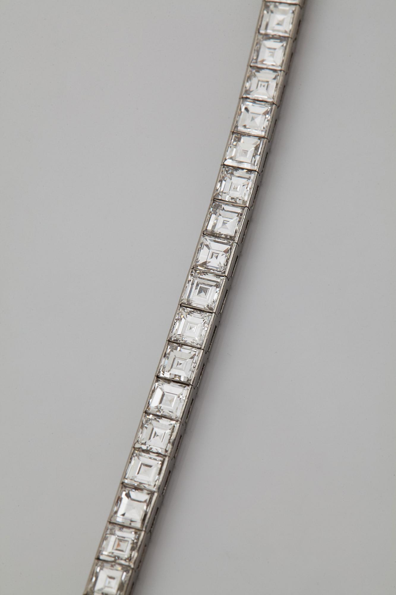 A platinum bracelet set with carré cut diamonds.