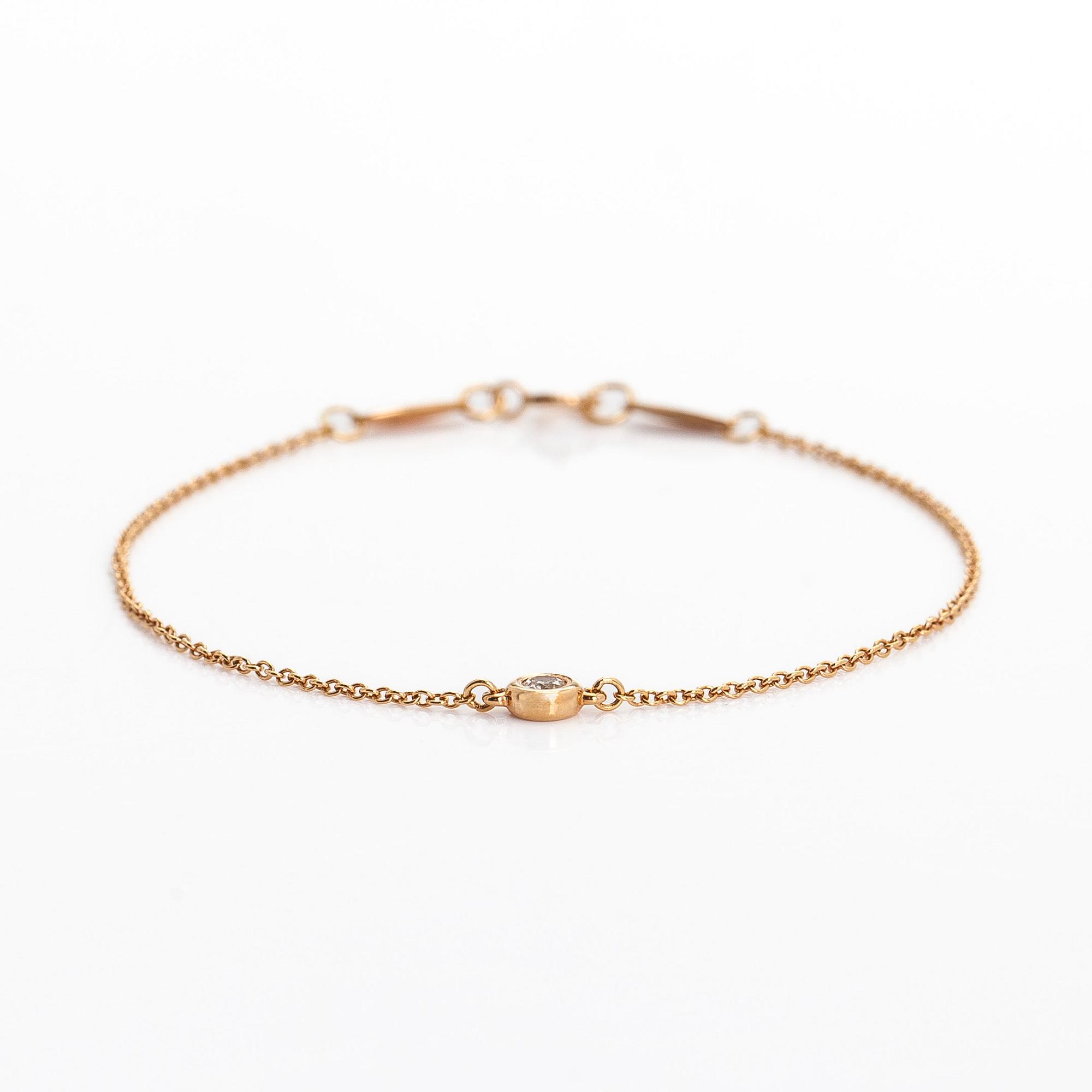 Tiffany & Co, Elsa Peretti, an 18K gold bracelet, 'Diamonds by the Yard', with a diamond approximately 0.08 ct.