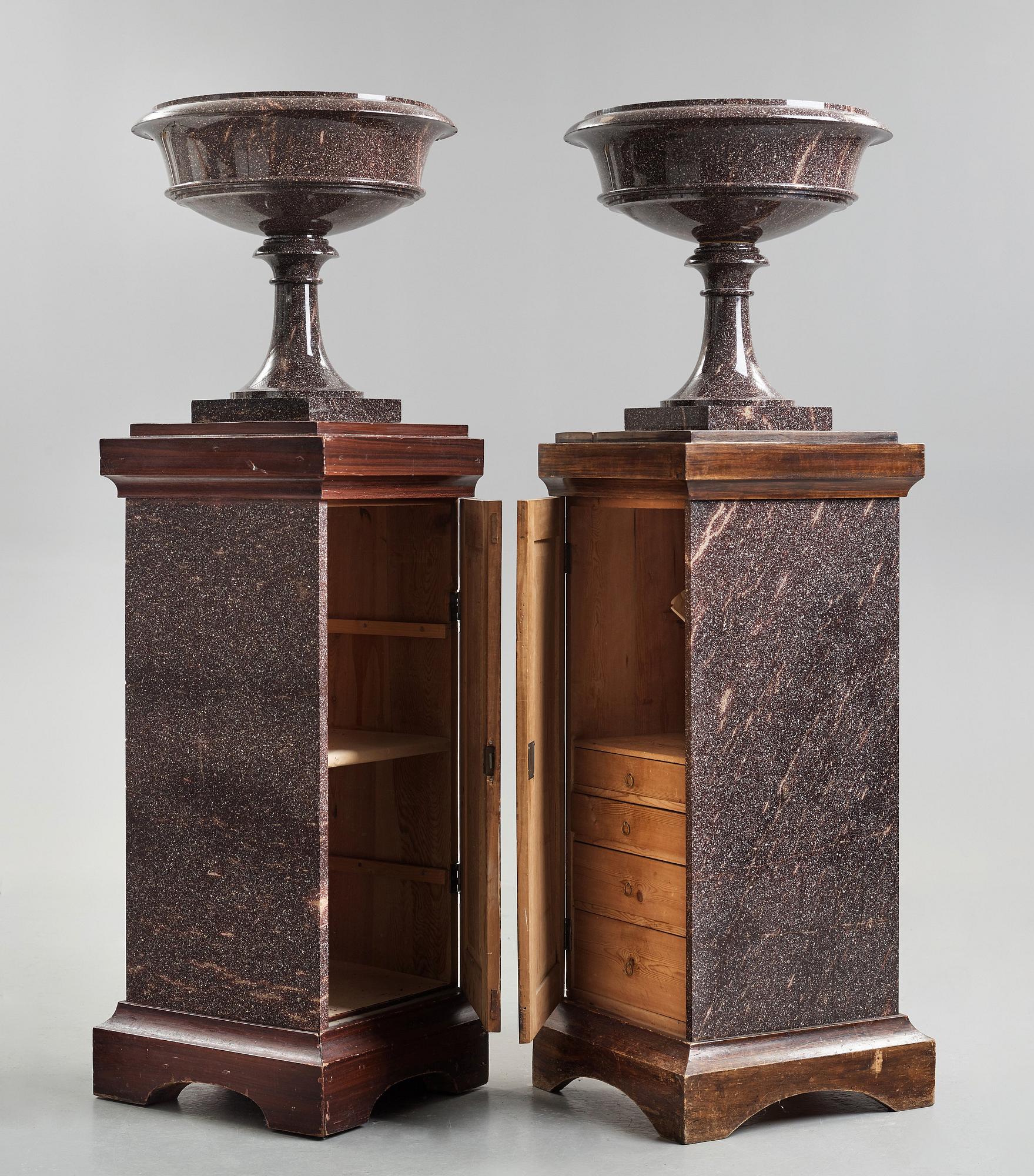 A pair of Swedish porpyry vases on wooden bases, Älvdalen, first half of the 19th century.