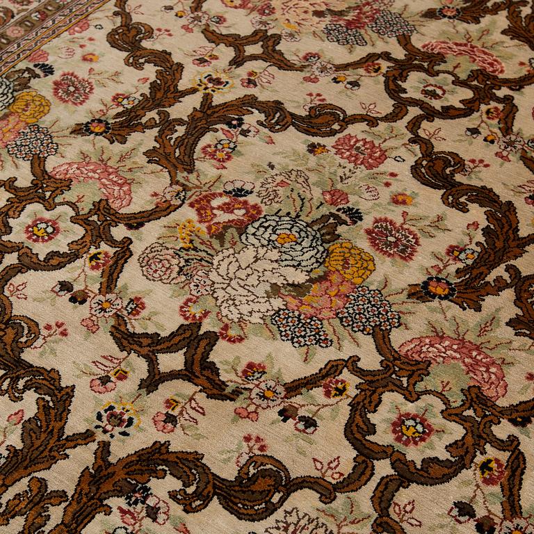 A silk Qum rug, around 220 x 134 cm.