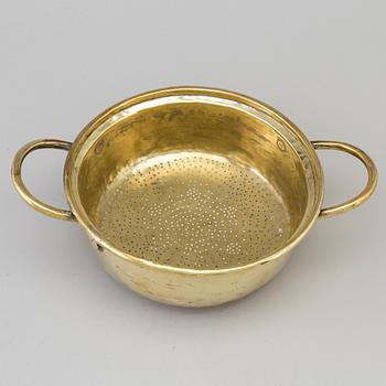 An 18th century brass colander.
