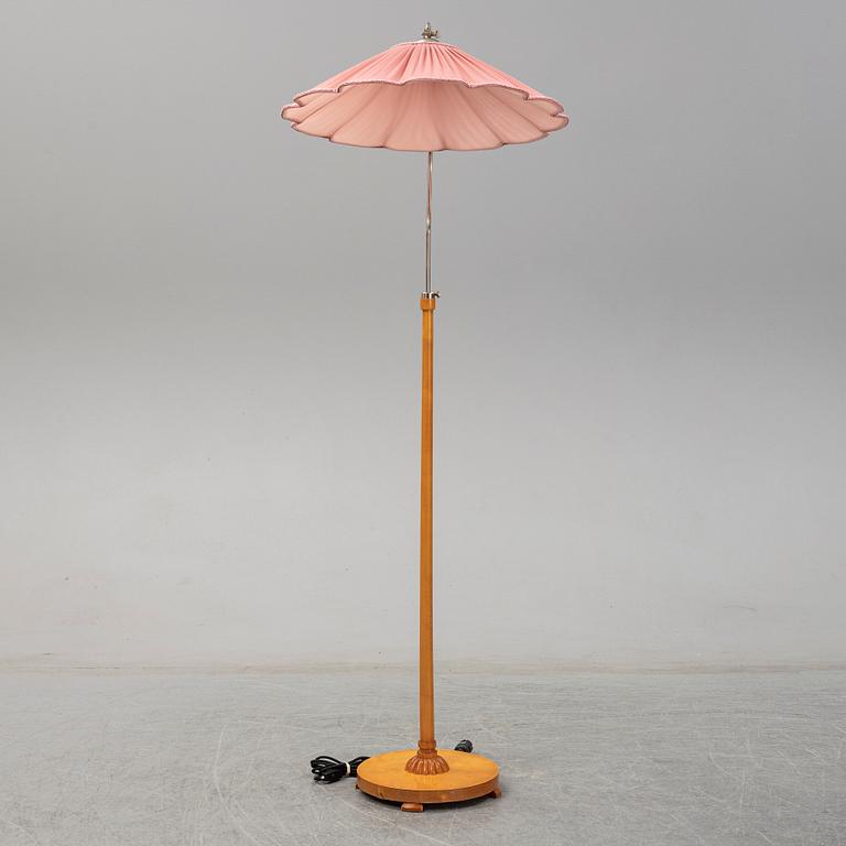 A 1940s birch wood floor lamp.