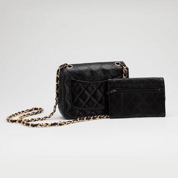 CHANEL, a black quilted leather "Mini flap" bag and wallet.