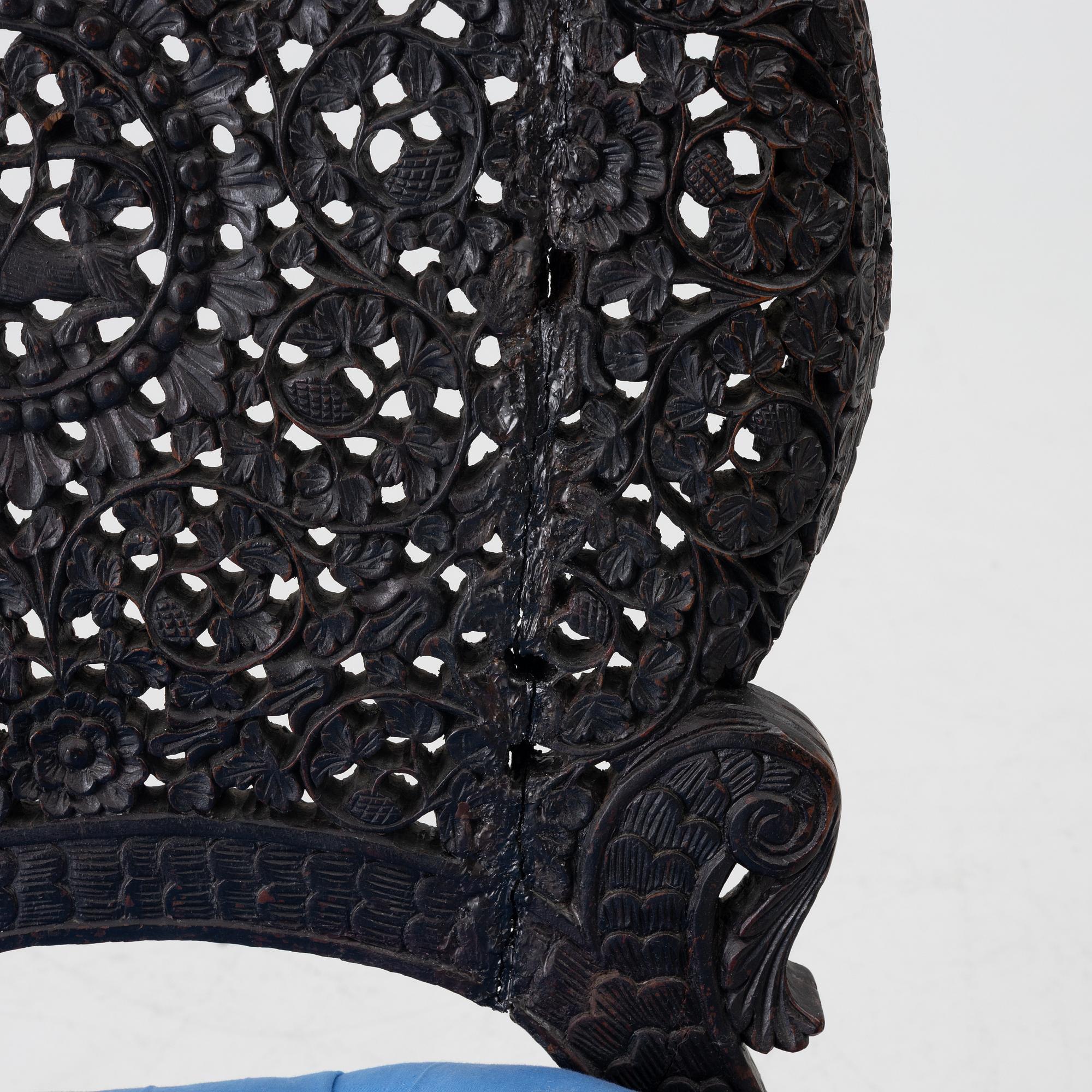 A carved 'blackwood' armchair.  bombay presidency circa 1880.
