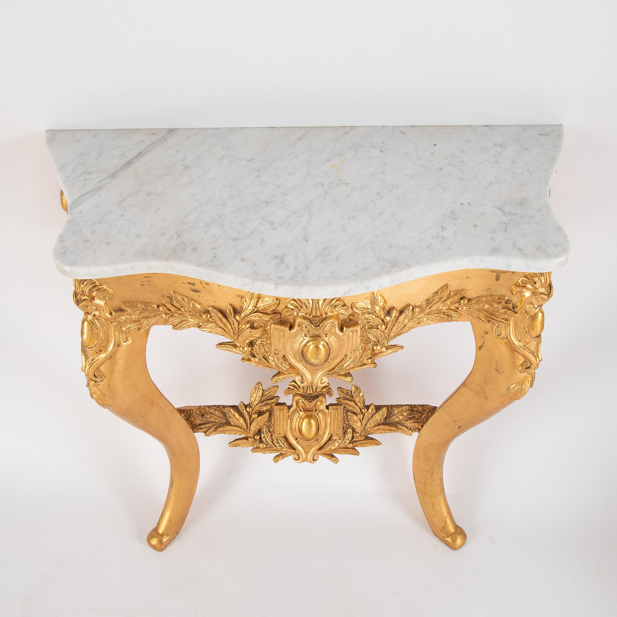 A mirror and console table from around the year 1900.