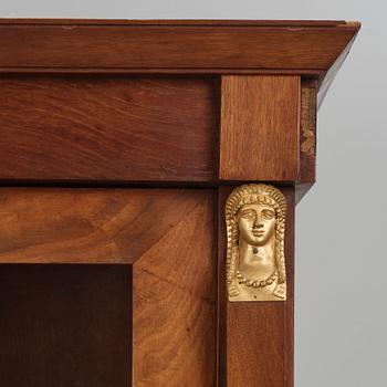 A French Empire mahogany and gilt-bronze mounted bibliothèque, early 19th century.