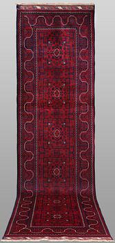 A Afghan runner carpet, 304 x 84 cm.