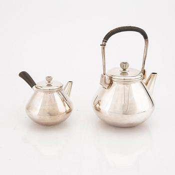 A set of two Japanese early 20th century sterling silver tea pots weight 474 grams.