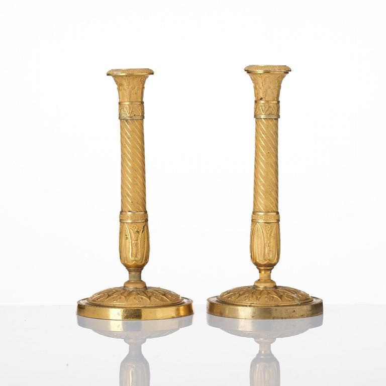 A pair of French Empire ormolu candlesticks, Paris, early 19th century.
