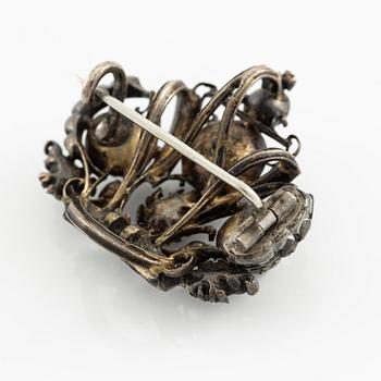 A brooch, a brooch pin, and a pendant, likely 19th century.