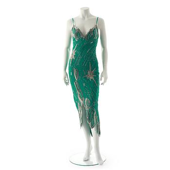 FABRICE, a green silk evening dress with glass bead embellishment.