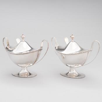 A pair of lidded silver sugar bowls with sprinkle spoons, mark of The Firm Carl Fredrik Carlman, Stockholm 1928-29.