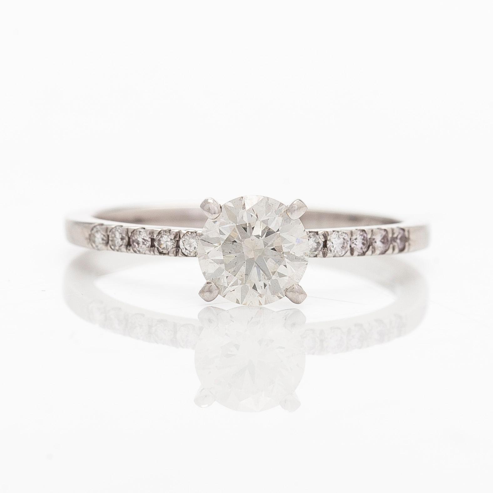 A 14K white gold ring with brilliant-cut diamonds.