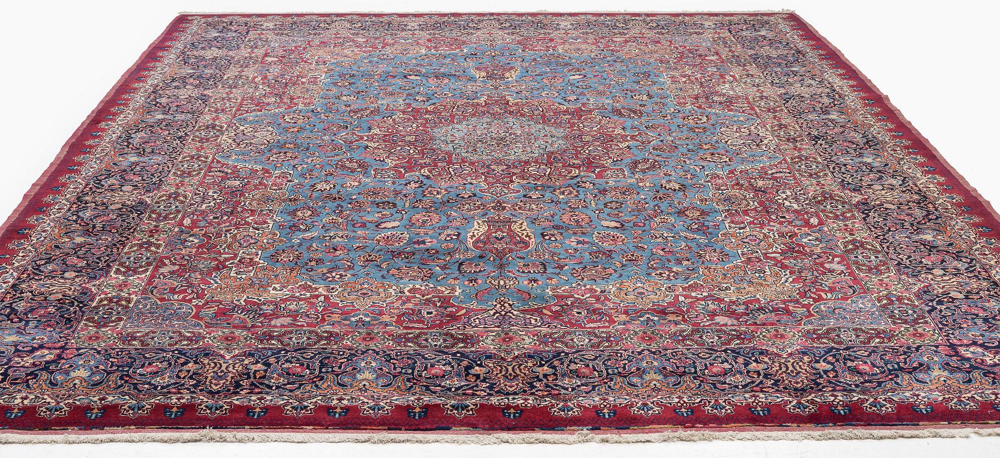 A Mashad carpet, signed Saber, c. 468 x 348 cm.