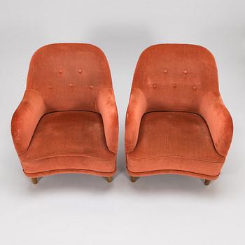 A pair of mid-20th-century armchairs.