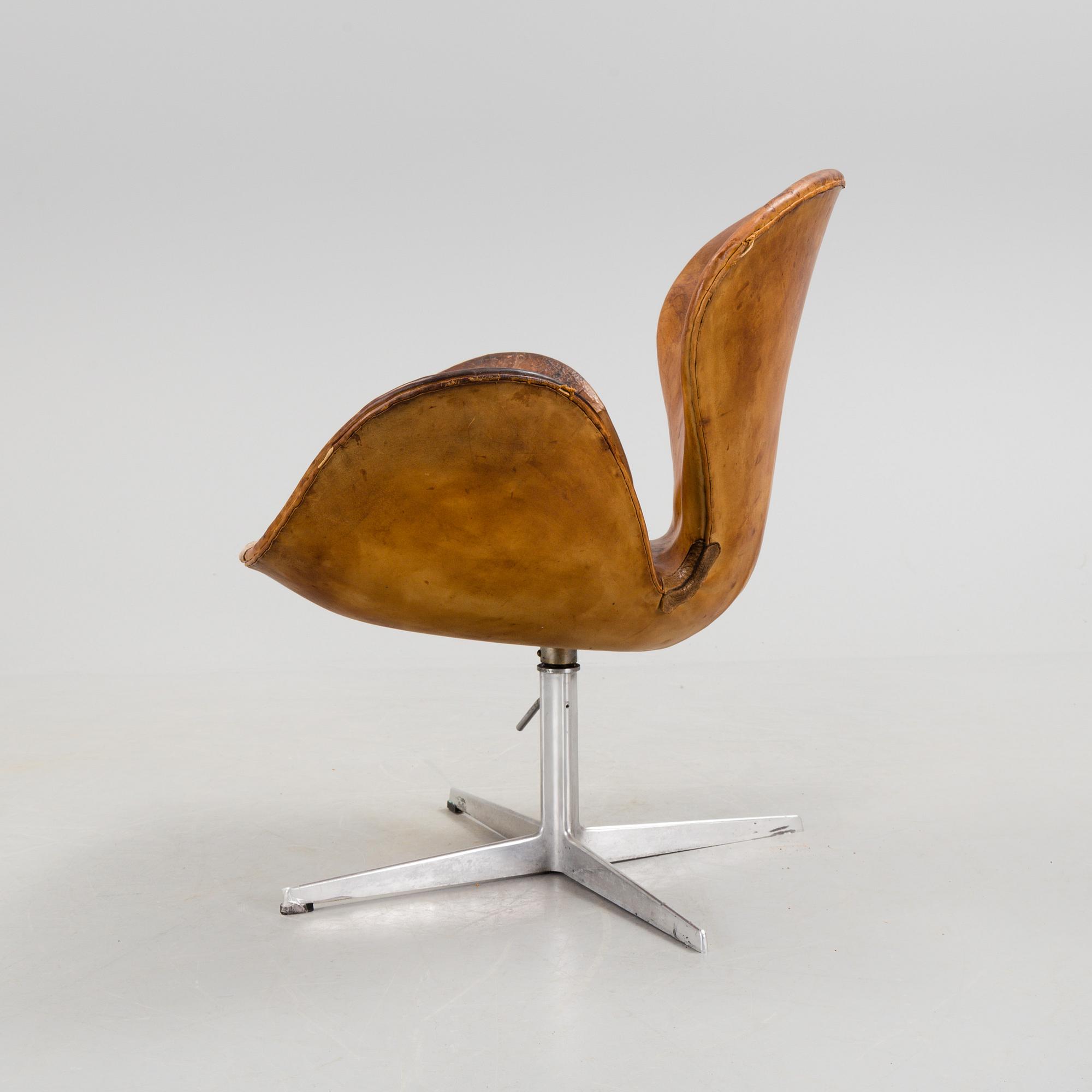 An Arne Jacobsen steel and brown leather 'Swan' chair, Fritz Hansen, Denmark 1960's.