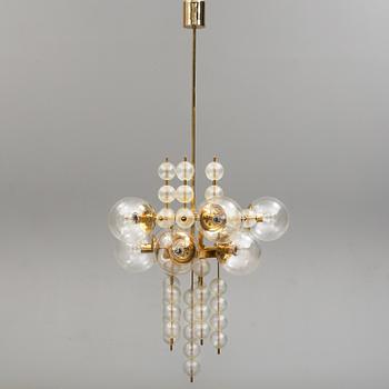 A 1970s brass ceiling light with glass shade. Height ca 144.