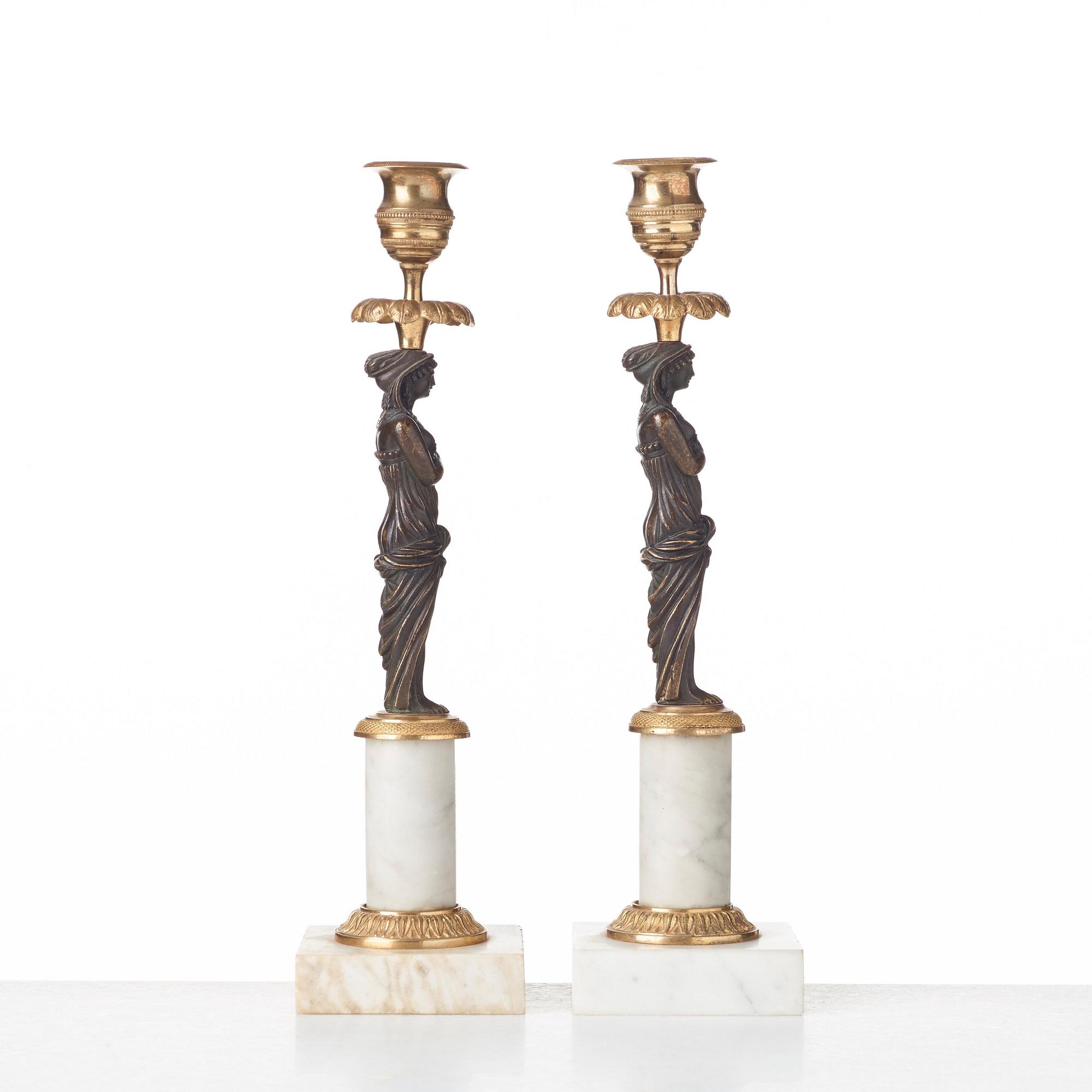 A pair of late Gustavian circa 1800 white marble and bronze candlesticks.