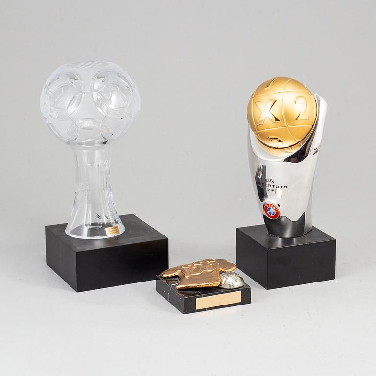 A collection of three soccer sculptures.