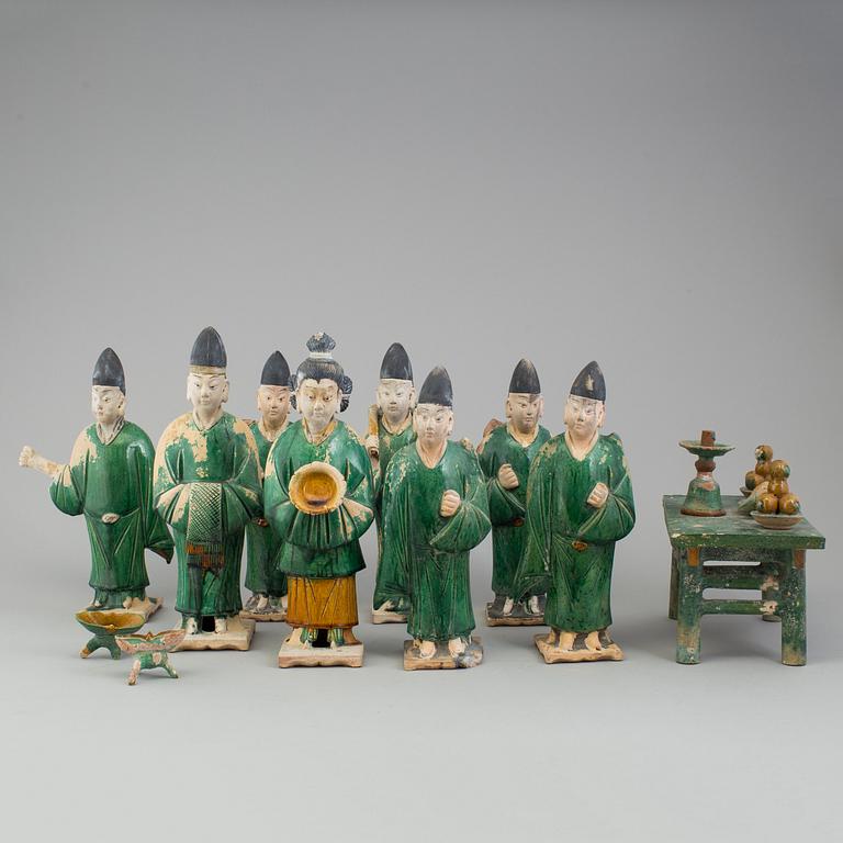 A group of eight chinese figures with three objects, earthenware, Ming dynasty.