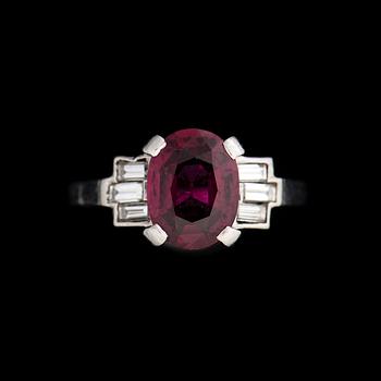 A RING, facetted ruby, baguette cut diamonds, platinum.