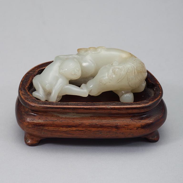 A Chinese nephrite figure of a reclining horse and a monkey, early 20th Century.