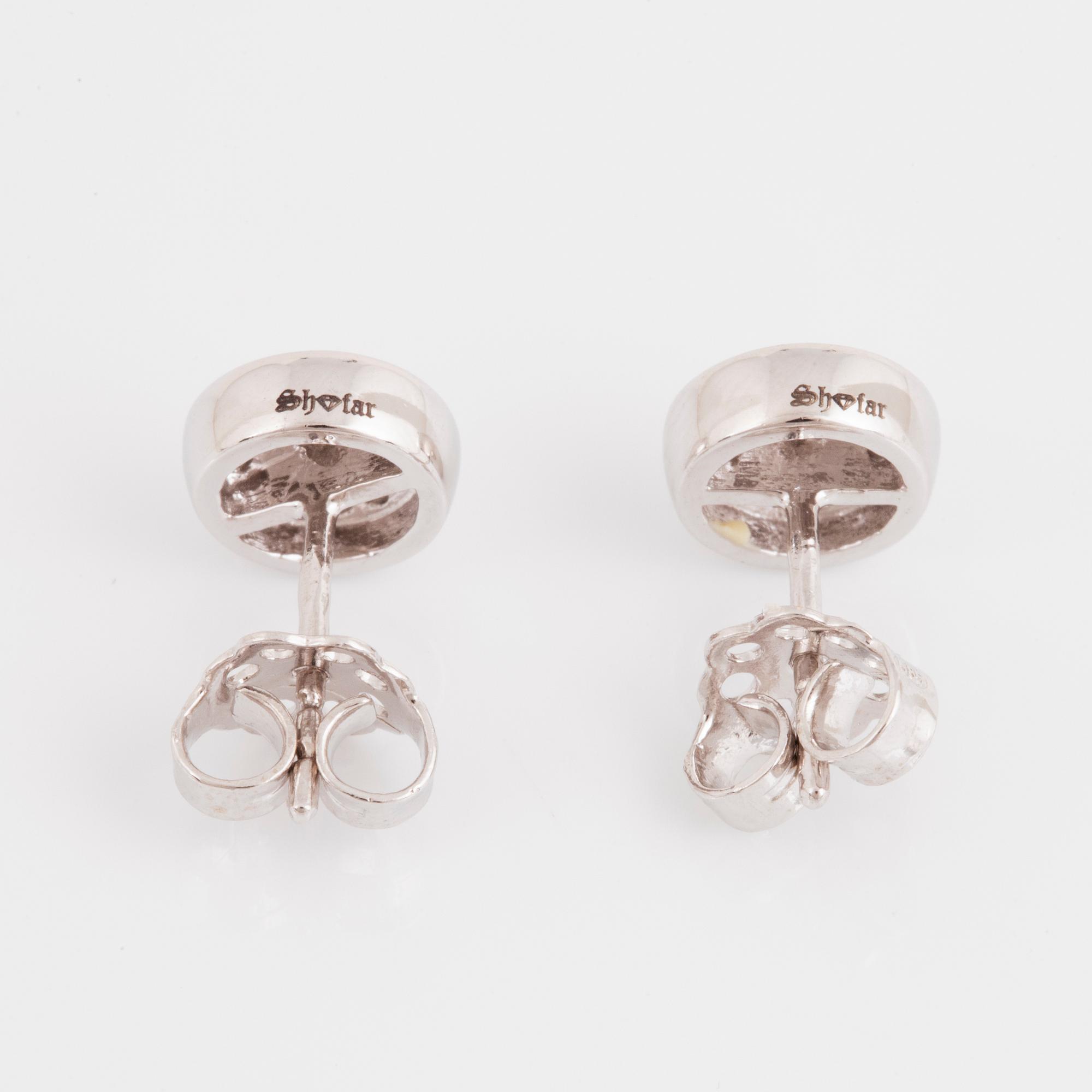 A pair of 14K gold earrings set with round brilliant-cut diamonds.
