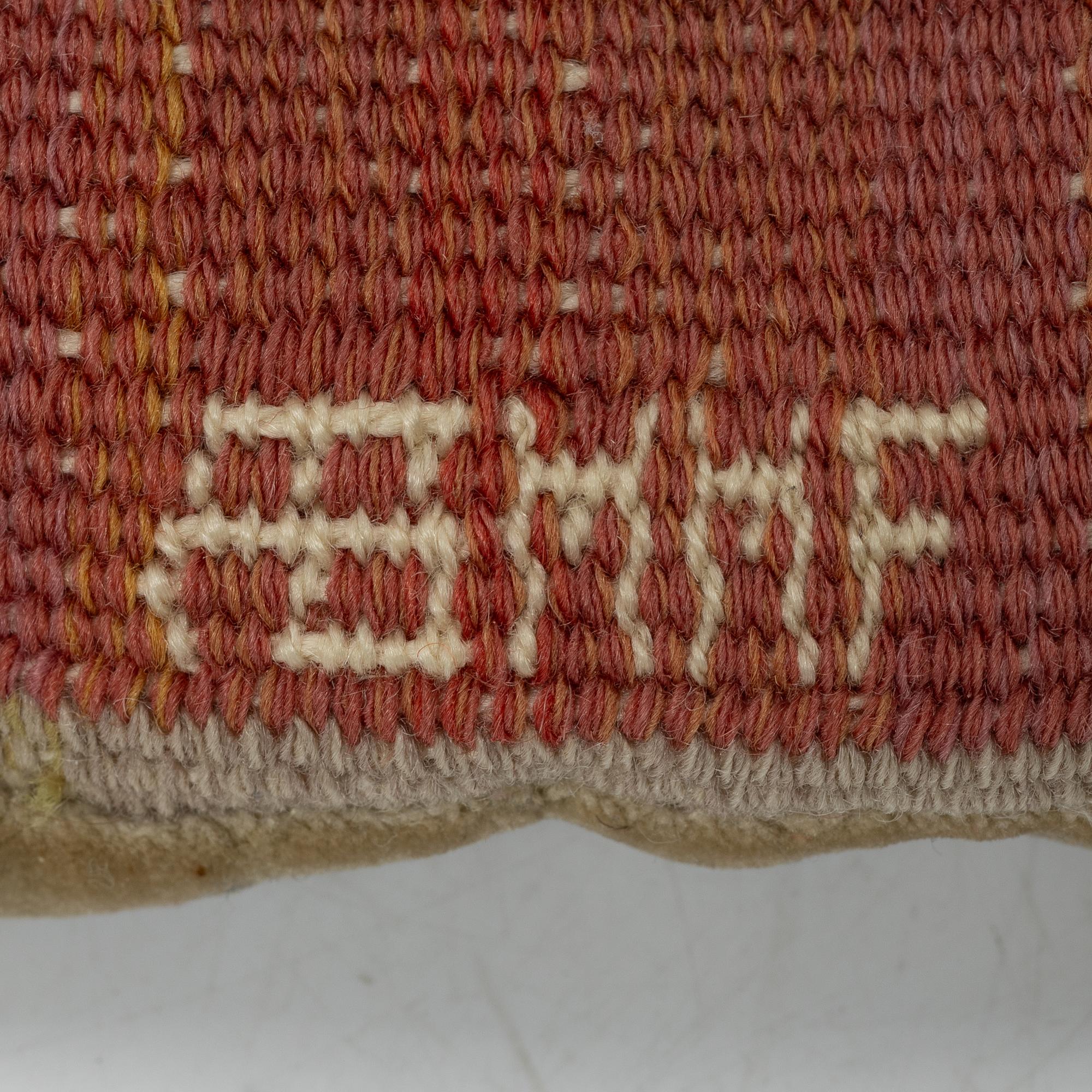 Märta Måås-Fjetterström, a cushion, 'Blommor på röd botten', signed AB MMF, ca. 31 x 31 cm.