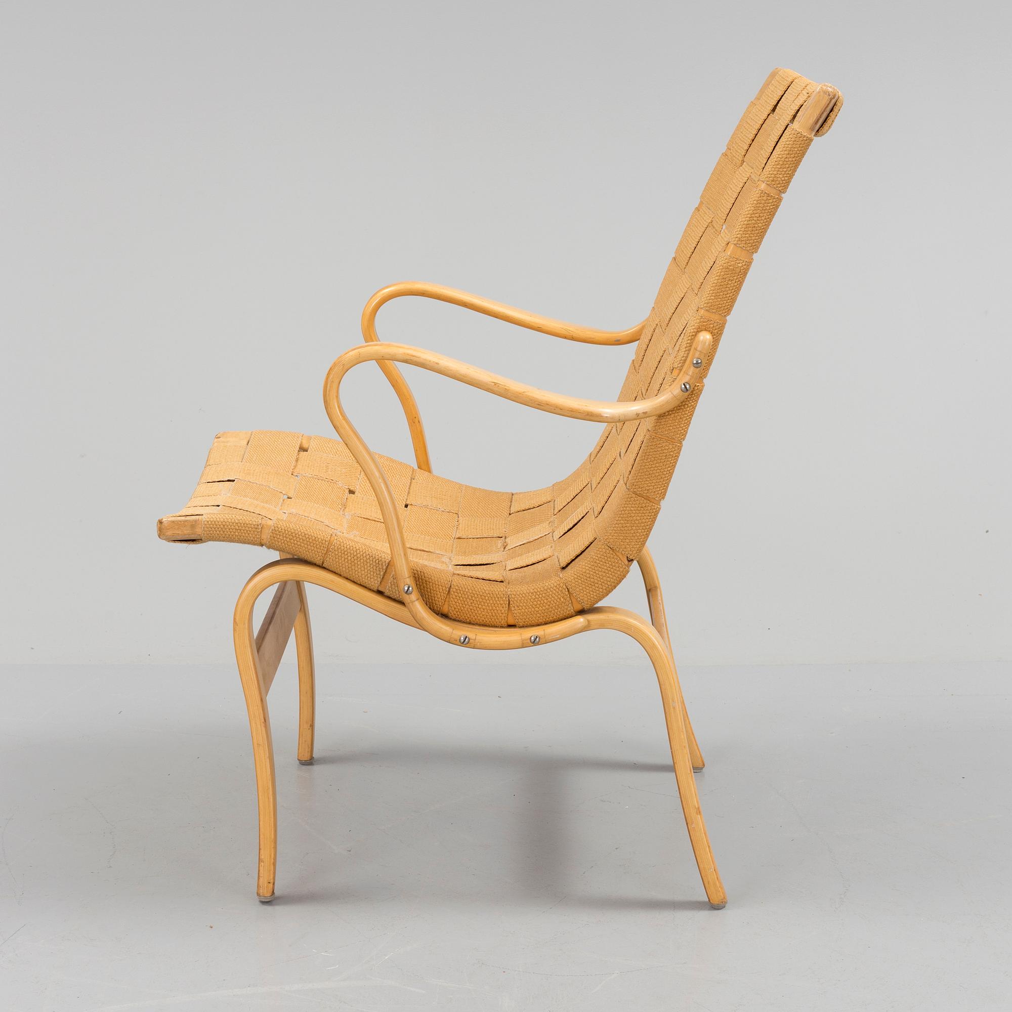 an "Eva" armchair by BRUNO MATHSSON 1963.
