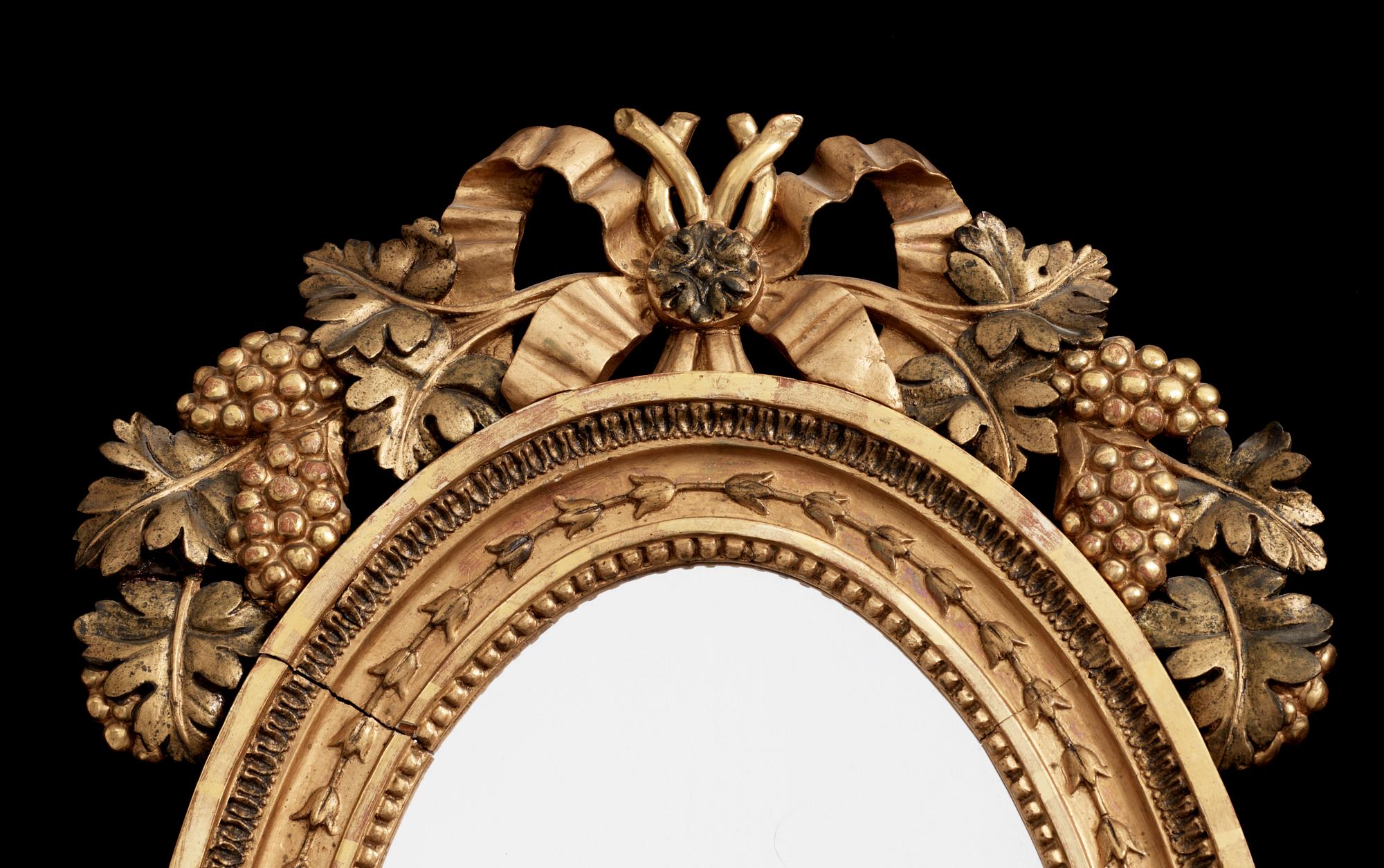 A pair of Swedish Empire early 19th century two-light girandole mirrors.