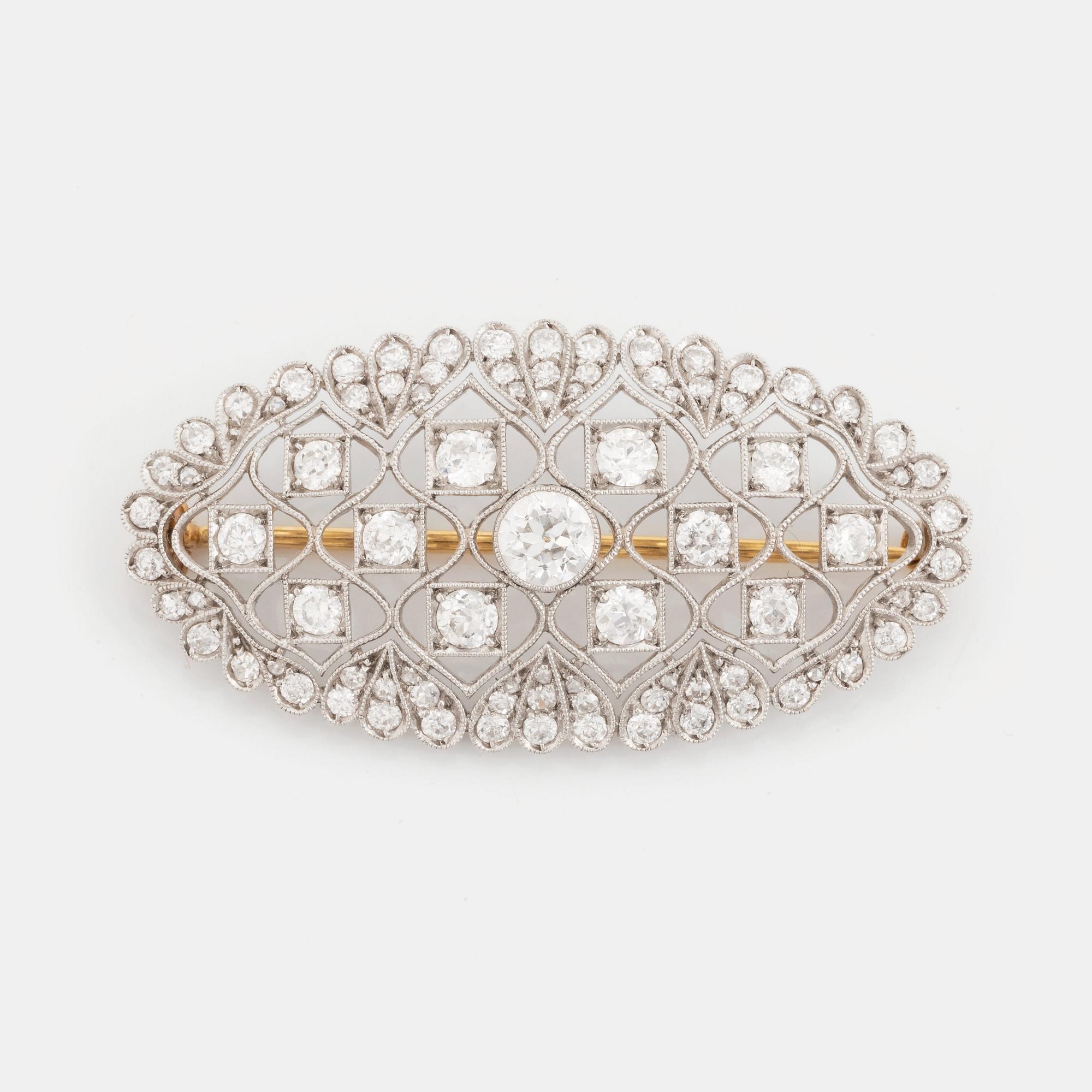 A platinum and gold brooch set with old-cut diamonds.