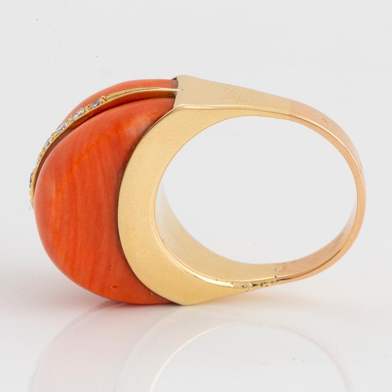 An 18K gold and coral ring set with eight-cut diamonds.