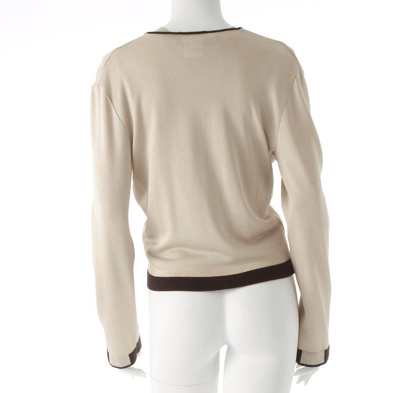 CHANEL, a gold colored and brown sweater set consisting of a sleevles top and cardigan.