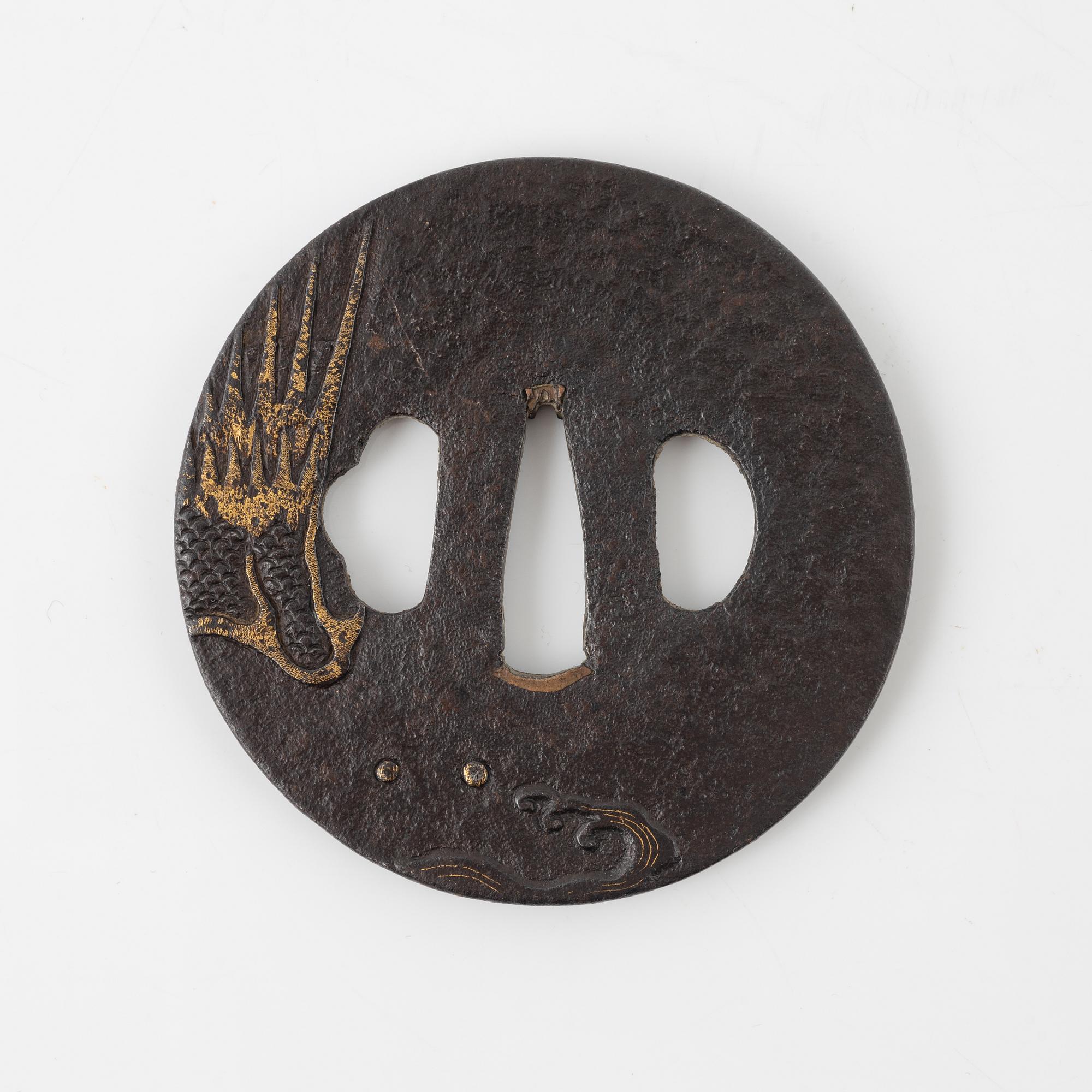 A round iron tsuba decorated with a dragon, Japan, Edo-period,