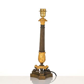 A French Empire ormolu and patinated bronze table lamp, early 19th century.