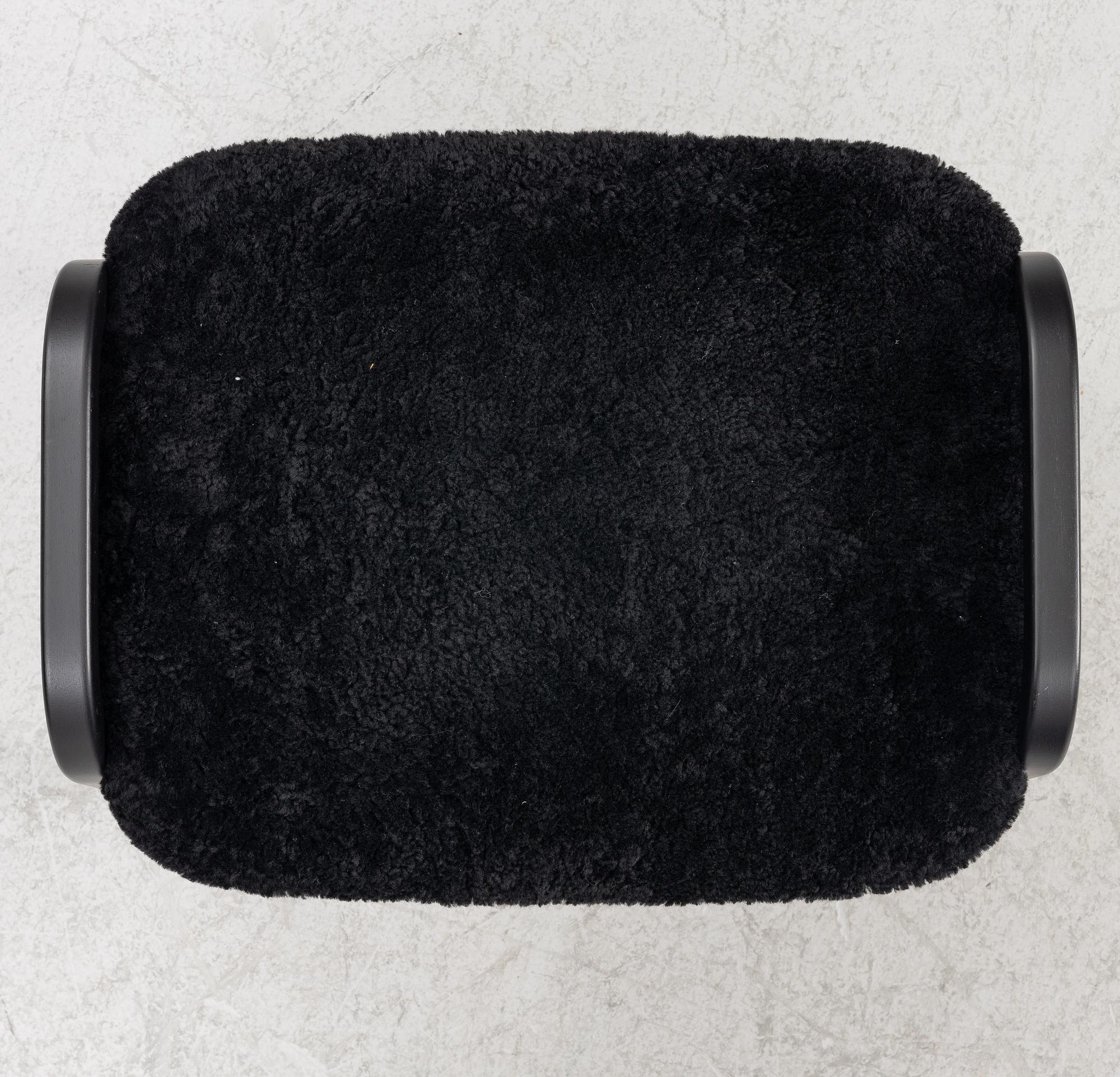 Yngve Ekström, a  'Lamino' easy chair with foot stool, Swedese, 2018.