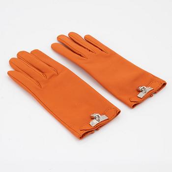 Hermès, a pair of orange kidskin and lambskin gloves, french size 8.