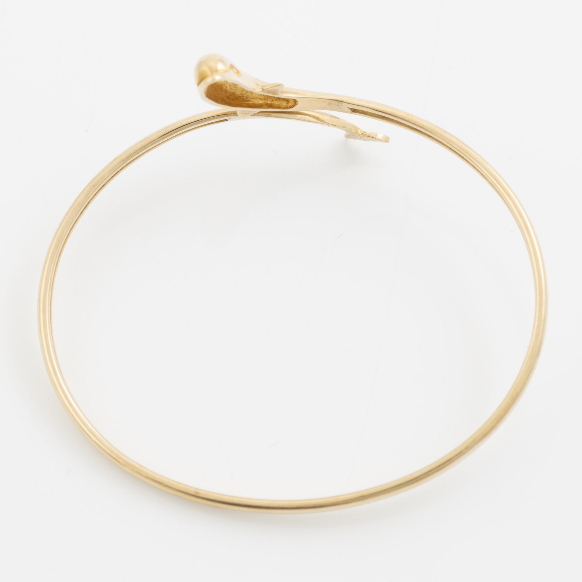 Bracelet/arm ring, 14K gold in the form of a dolphin.