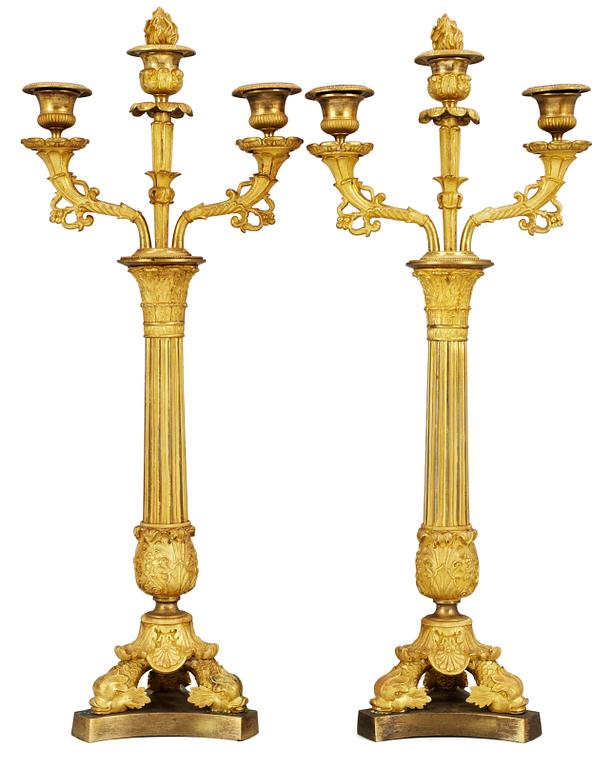 A pair of French Empire three-light candelabra.