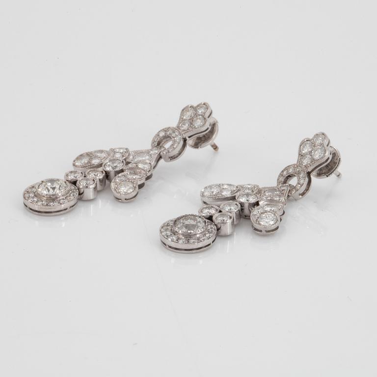 A pair of 18K white gold earrings set with old- and round brilliant-cut diamonds.