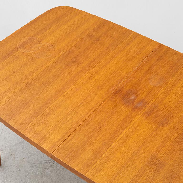 A dining table with six chairs, mid 20th century.