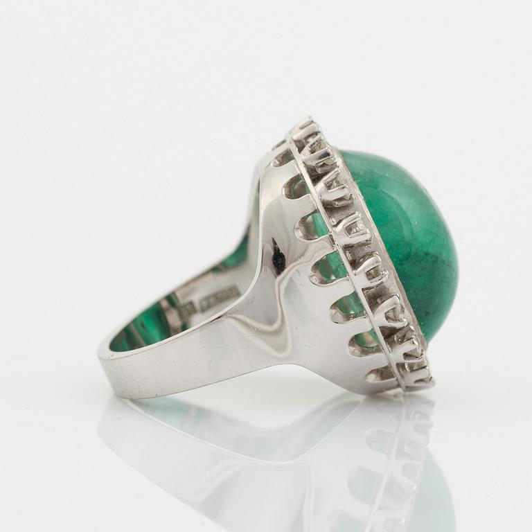 Cabochon cut emerald and brilliant cut diamond ring.