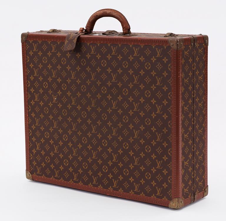 A monogram canvas suitcase by Louis Vuitton.