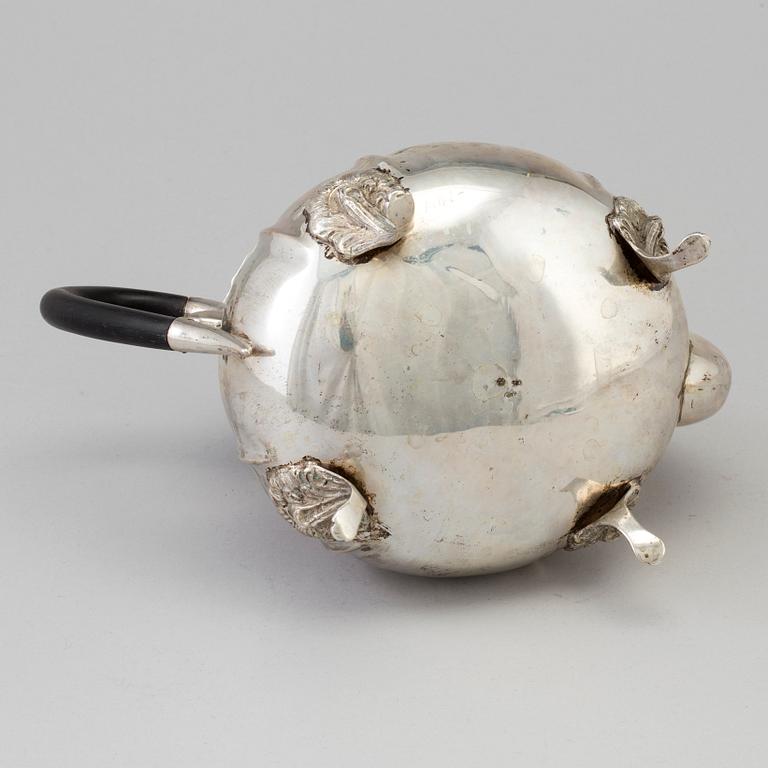 A silver rococo style teapot.